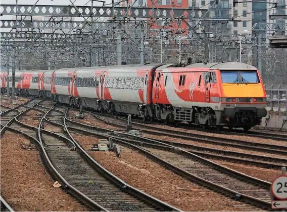  ?? ANDREW STOPPARD. ?? Virgin Trains East Coast tickets are dearer than VT’s West Coast operations, due to the legacy of British Rail days when the East Coast was more expensive because of modernisat­ion. On April 4 2016, Virgin Trains East Coast 91108 snakes its way from...