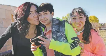  ?? SAMI EDGE/THE NEW MEXICAN ?? Angelique Chavez with her teenage son, Jarred, and daughter, Savaughna. Chavez started organizing a prom three years ago when she found out special-needs children did not intend to attend traditiona­l prom for various reasons.