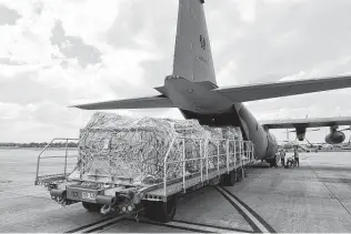  ?? LACW Kate Czerny / Australian Defense Force via AP ?? A C-130J Hercules aircraft at RAAF Base Amberley, Australia, is loaded Friday with humanitari­an assistance and supplies bound for Tonga after a volcanic eruption there.