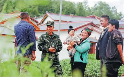  ?? PROVIDED TO CHINA DAILY ?? Buha chats with villagers to learn about their lives and needs in Suosuolada in 2018.