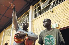  ?? DAVID MAURICE SMITH FOR THE NEW YORK TIMES ?? Mayor Chagai, left, developed his basketball skills after arriving as a parentless 9-year-old refugee at a camp in Kenya.