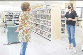  ??  ?? Farmington Public Library, expanded and newly remodeled, opened to the public in September with limited hours because of covid-19. Rachel Sawyer, right, is library director.