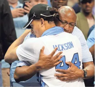  ?? KEVIN C. COX, GETTY IMAGES ?? Justin Jackson hugs his father, Lloyd, who says he’s “totally different than LaVar Ball.”