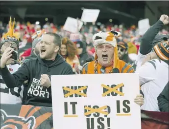  ?? Margaret Bowles Associated Press ?? BENGALS FANS celebrate after Cincinnati beat Kansas City in the AFC championsh­ip game to reach the Super Bowl for the first time since 1989. The team won six games combined the previous two seasons.