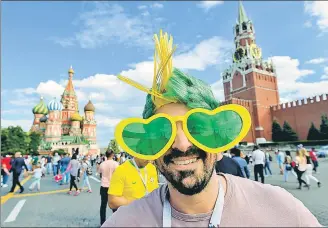 ?? AFP ?? ■ The World Cup has turned Russia into one big football party and a Brazil fan is soaking it all in.