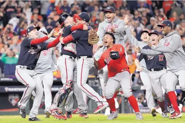  ?? DAVID J. PHILLIP/ASSOCIATED PRESS ?? Washington players celebrate after the Nationals beat the Astros in Game 7 to win the first World Series in franchise history.