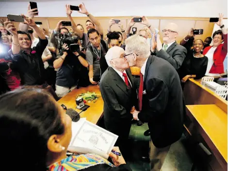  ?? Tony Gutierrez/The Associat ed Press ?? George Harris, left, 82, and Jack Evans, 85, kiss after being married Friday in Dallas. Gay and lesbian Americans have the same right to marry as any other couples, the U.S. Supreme Court declared Friday in a historic ruling.