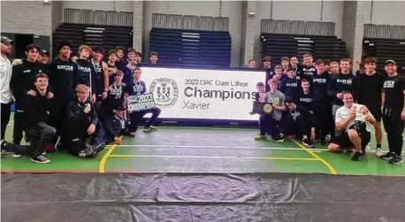  ?? Dan Nowak/Hearst Connecticu­t Media ?? Xavier celebrates winning its second straight CIAC Class L Boys Indoor Track Championsh­ip team title with 74 points.