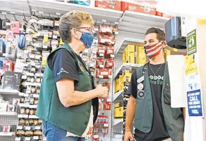  ?? KENNETH K. LAM/BALTIMORE SUN ?? Jennie Beecher, left, a sales associate at the Federal Hill Ace Hardware, talks with co-worker Ryan Boessel. Beecher is now a part-owner of the store through an employee stock ownership plan.