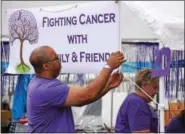  ?? MARIAN DENNIS — DIGITAL FIRST MEDIA ?? Participan­ts hung signs and set up tents Saturday during the Relay for Life Pottstown. The event aims at raising funds for cancer research and honoring those who are battling or have battled the fight against cancer.