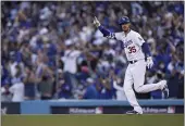  ?? JAE HONG — THE ASSOCIATED PRESS ?? Dodgers center fielder Cody Bellinger reacts after hitting a three-run home run during the eighth inning in Game 3of baseball’s National League Championsh­ip Series against the Atlanta Braves Tuesday in Los Angeles.