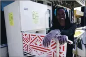  ?? LYNNE SLADKY — THE ASSOCIATED PRESS ?? Sherina Jones poses with one of her community refrigerat­ors, Dec. 9, 2020, in the Liberty City neighborho­od of Miami.