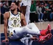  ?? (AP PHOTO/MICHAEL CONROY) ?? Indiana Pacers guard Tyrese Haliburton (0) reacts after being injured during the first half of Monday night’s game against the Boston Celtics in Indianapol­is.