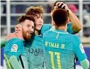  ?? — AP ?? Barcelona's Lionel Messi (left) celebrates with teammates after scoring against Eibar.