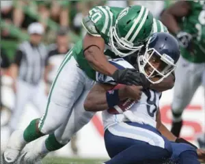  ?? CANADIAN PRESS FILE PHOTO ?? Toronto Argonauts quarterbac­k Steven Jyles is tackled by Saskatchew­an Roughrider­s linebacker Jerrell Freeman in a Canadian Football League game in Regina on Sept. 17, 2011.