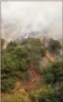  ?? THE ASSOCIATED PRESS ?? A crew with California Department of Forestry and Fire Protection (Cal Fire) battles a brushfire on the hillside in Burbank Saturday.