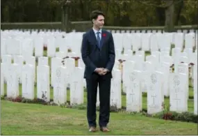  ?? ADRIAN WYLD/THE CANADIAN PRESS VIA AP ?? Canadian Prime Minister Justin Trudeau stands among the military gravestone­s Saturday as he visits the Canadian Cemetery No. 2 near Vimy Ridge, France.