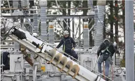  ?? Photograph: Anadolu Agency/Getty Images ?? Workers repair damage from gunfire at an electrical substation in North Carolina in December 2022.