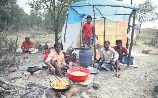  ?? Picture: Reuters ?? DOWN AND OUT. A man cooks a meal in a makeshift restaurant on Bhasan Char in the Bay of Bengal recently. About 100 000 Rohingya refugees will soon be relocated there from Bangladesh’s mainland.