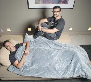  ?? PETER J THOMPSON / FOR FINANCIAL POST ?? Gravid.ca co-founders Omar Shahban, right, and Fahd Javed show off their new design of weighted blanket in Toronto last month.