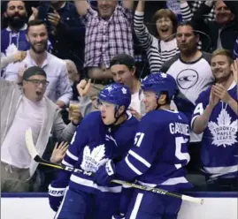  ?? FRANK GUNN, THE CANADIAN PRESS ?? Toronto Maple Leafs centre Auston Matthews, left, celebrates his game-winning goal with teammate Jake Gardiner. Toronto trailed 2-0 in the first, but won, 4-3 in overtime.