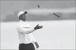  ?? ASSOCIATED PRESS ?? TIGER WOODS of the United States throws his club in the air on the 5th green during the second round of the British Open Golf Championsh­ips at Royal Portrush in Northern Ireland, Friday.