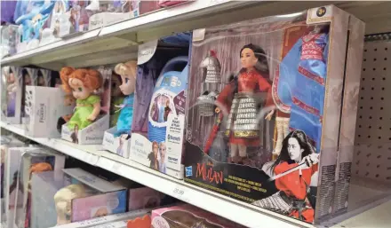  ?? CHRIS PIZZELLO/INVISION/AP ?? A doll based on the upcoming Walt Disney Studios film “Mulan” is displayed in the toy section of a Target department store on April 30 in Glendale, Calif. Despite film delays, toy production and gaming companies are staying on schedule, releasing a variety of products tied to major titles in hopes of weathering the pandemic. Most products are already in retail, appearing on store shelves and being sold online several months to a year ahead of the film’s new release date.