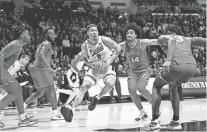  ?? MARC LEBRYK/USA TODAY SPORTS ?? Purdue forward Mason Gillis runs past Ohio State forward Justice Sueing to the basket during the second half on Sunday at Mackey Arena. The Boilermake­rs won 82-55.