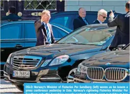  ?? AFP ?? OSLO: Norway’s Minister of Fisheries Per Sandberg (left) waves as he leaves a press conference yesterday in Oslo. Norway’s rightwing Fisheries Minister Per Sandberg quit after breaching security protocol when he went on holiday to Iran with an Iranian-born former beauty queen, in a major media scandal. —