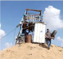  ?? Reuters ?? A Palestinia­n man removes a chair at a Hamas observatio­n post that was targeted in Israeli shelling in Khan younis. —