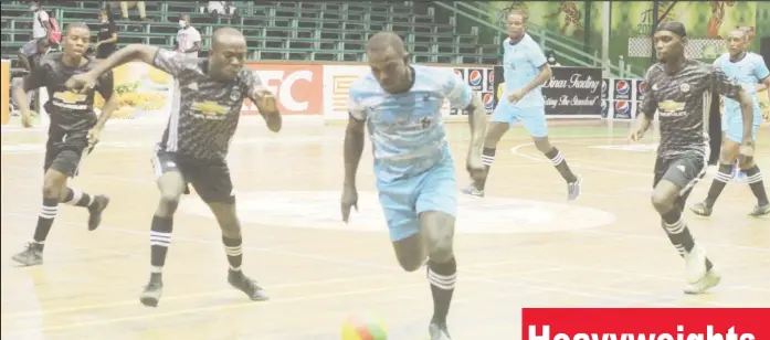  ?? ?? Selwyn Williams (right) of Back Circle on the attack against Timehri in the GFF/Kashif and Shanghai Organizati­on Futsal Championsh­ip at the Cliff Anderson Sports Hall