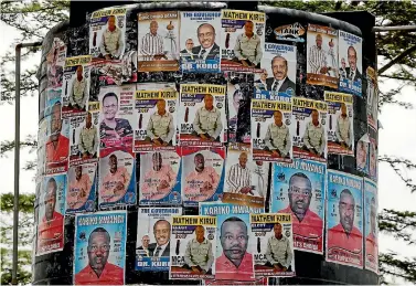  ?? PHOTO: REUTERS ?? Campaign posters of candidates for the role of local representa­tive are seen on a water tank in the Barut ward, Nakuru, Kenya.