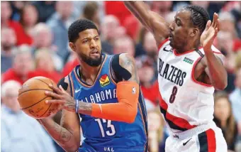  ?? AP PHOTO/CRAIG MITCHELLDY­ER ?? Paul George, left, looks to pass the ball around Portland Trail Blazers forward Al-Farouq Aminu while playing for the Oklahoma City Thunder during an NBA playoff game on April 16 in Portland, Ore. George is no longer with the Thunder, having headed further west to join the Los Angeles Clippers as part of a mega trade that could shift the balance of power in the league.