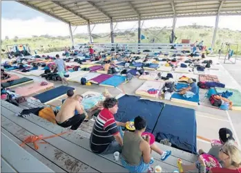  ?? Ezequiel Becerra AFP/Getty Images ?? AT A SHELTER in Costa Rica, near the border with Nicaragua, 300 Cuban migrants rest on their journey toward the U.S. Latin American officials have failed to find solutions to the increasing migration.