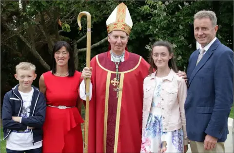  ??  ?? Fiona O’Mahony on her Confirmati­on day in Piercestow­n with her parents Anne and Rory, brother Daniel and Bishop Denis Brennan.