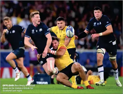  ?? ?? OFFLOAD: Ben Healy is hauled down as he makes a break for Scotland last night