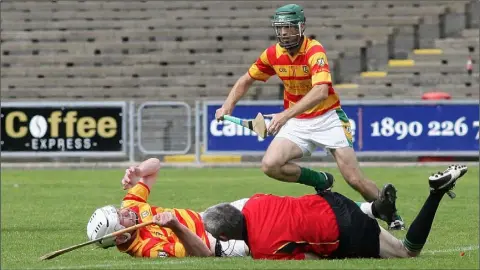  ??  ?? Referee Niall McDonald is sent crashing after an accidental collision with Alley captain Ciarán Kenny, but both were fine afterwards.