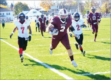  ?? Photo by Ernest A. Brown ?? Woonsocket junior running back Logan Coles rushed for a four-yard touchdown in the first quarter to help the Novans down Rogers, 35-7, Saturday afternoon at Barry Field. The Novans won their final four games of the regular season.
