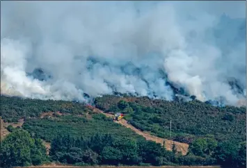  ??  ?? spread rapidly: A fire engine is dwarfed by the fire raging on Bray Head, Co. Wicklow, yesterday