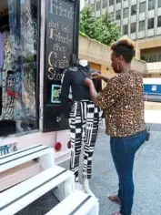  ??  ?? Lia Lee, owner of the Street Boutique fashion truck arranges a mannequin while waiting for customers in Crystal City, Virginia.