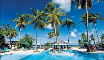  ?? ?? Slow the pace down: spend some quality hours really relaxing on the beach or at one of the resort’s inviting pools, one of which has a swim-up bar, pictured above