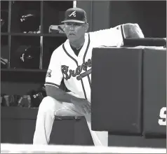  ?? File-TODD KIRKLAND / The Associated Press ?? Atlanta’s Brian Snitker looks on from the dugout during a game this past season at Turner Field.