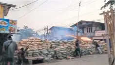  ??  ?? A protester sets off fireworks from behind a makeshift barricade while clashing with security forces during a crackdown on rallies in Bago.