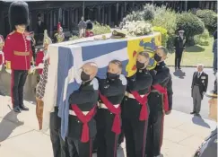  ?? PHOTO: GETTY ?? The coffin is carried into St George’s Chapel.