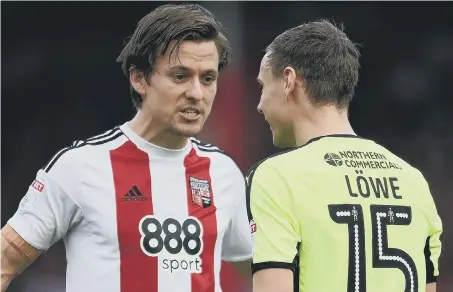  ??  ?? Lasse Vibe (left) confronts a Huddersfie­ld opponent in action for Brentford last season.