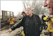  ?? Carolyn Cole Los Angeles Times ?? GOV. JERRY BROWN surveys damage from the Camp fire last week at Paradise Elementary School.