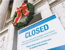  ?? ANDREW CABALLERO-REYNOLDS/AFP/GETTY IMAGES ?? A sign at the National Archives building in Washington, D.C., indicates it is closed because of the partial government shutdown. About 800,000 federal employees will go without pay days before Christmas, though about 420,000 of them will have to work anyway.