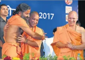  ?? VINAY PANDEY/HT PHOTO ?? CM Yogi Adityanath greets yoga guru Baba Ramdev during a function in Lucknow on Wednesday.