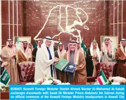  ??  ?? KUWAIT: Kuwaiti Foreign Minister Sheikh Ahmed Nasser Al-Mohamed Al-Sabah exchanges documents with Saudi Oil Minister Prince Abdulaziz bin Salman during an official ceremony at the Kuwaiti Foreign Ministry headquarte­rs in Kuwait City yesterday. — KUNA