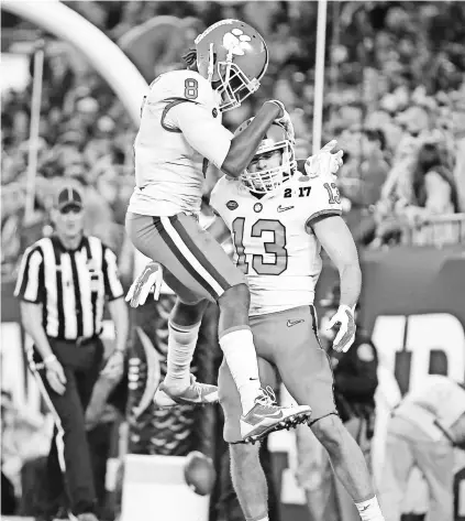  ?? MATTHEW EMMONS, USA TODAY SPORTS ?? Tigers receiver Hunter Renfrow, right, has been a standout in the last two national title games.